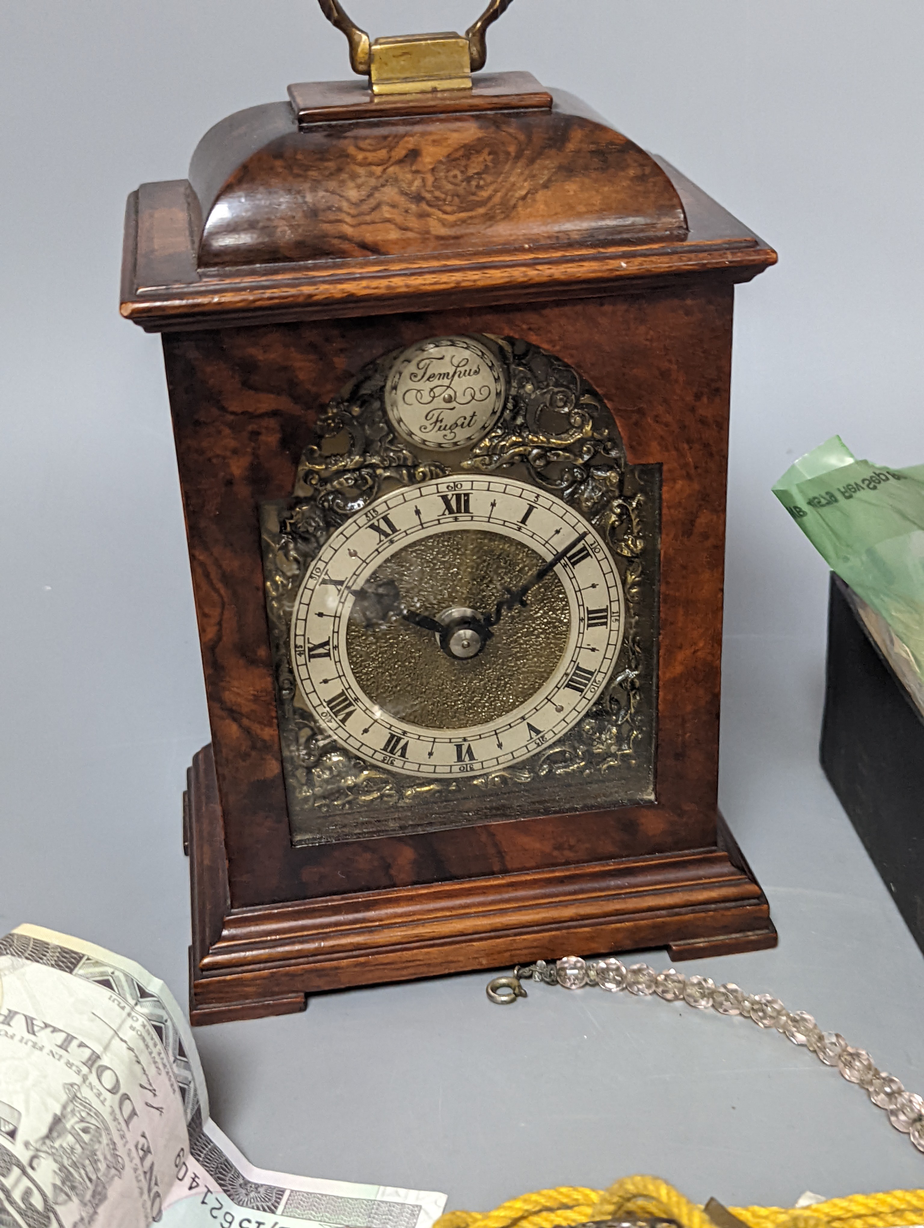 A pair of silver spoons, a small timepiece, assorted coinage and sundries